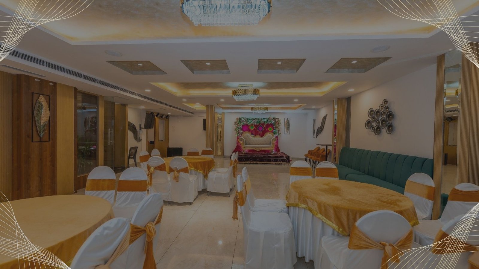 Spacious banquet hall with elegant lighting, round table seating, and stage setup for events